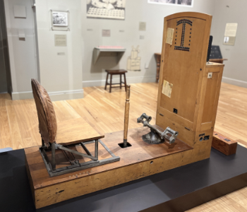 Wooden apparatus with a chair, yoke stick, and light panel